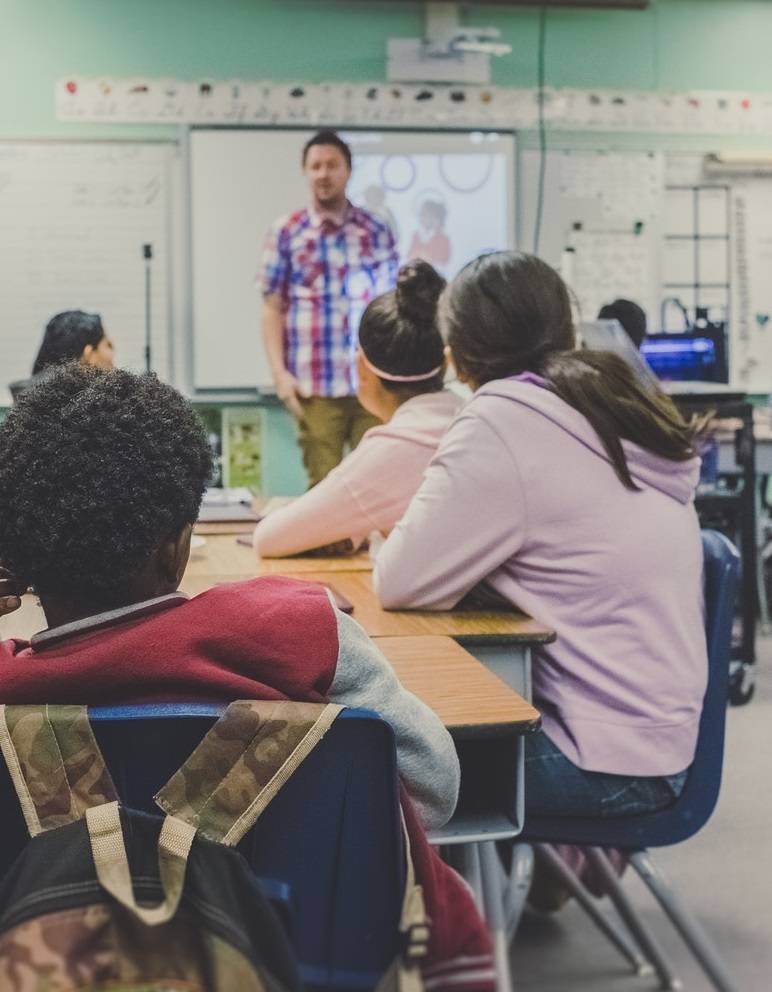 A man in front of a classroom teaching