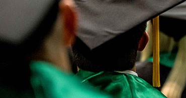 Close up of student wearing a graduation cap and gown