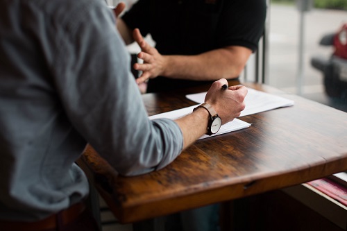 Two people sitting at a table talking