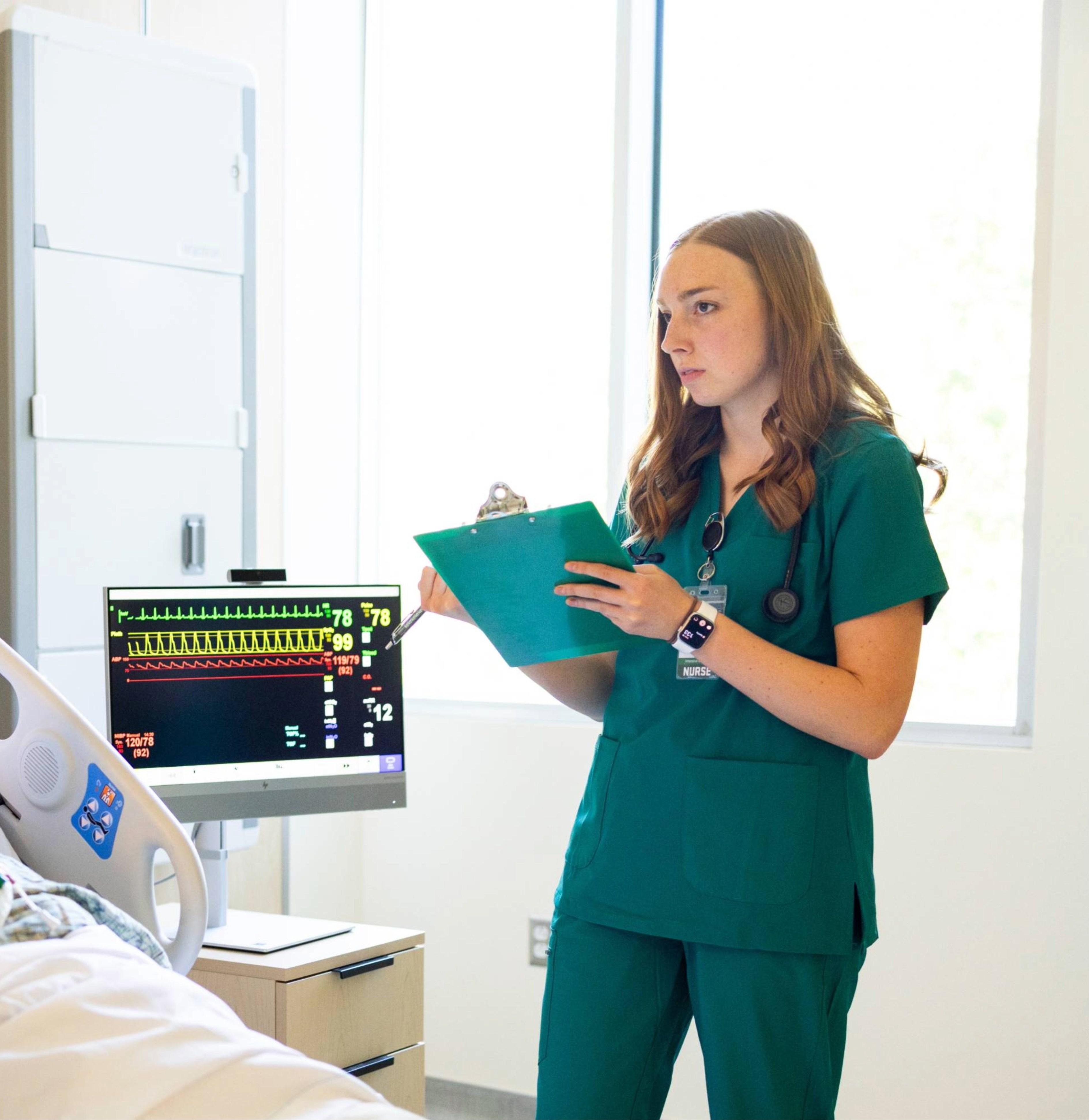 Respiratory Therapists speaking with a patient in the hallway.
