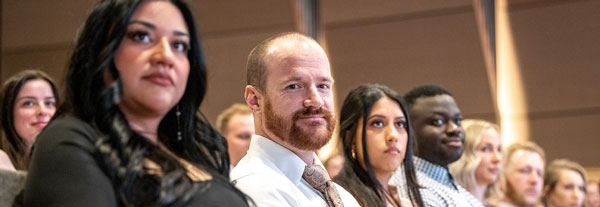 A group of faculty watching a presentation.