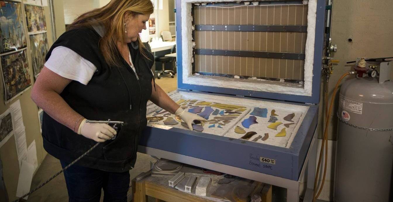 Step 6: person placing glass pieces into a kiln