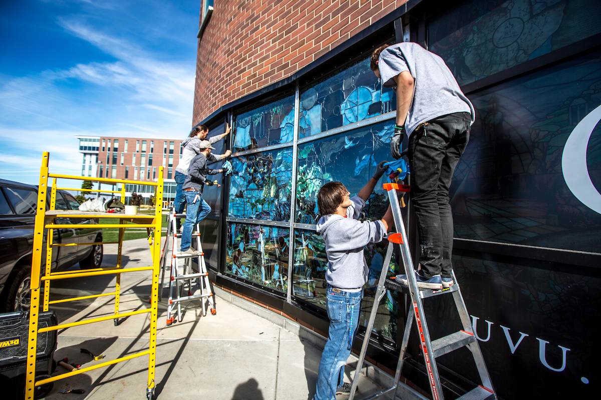 Image of workers installing the Roots of Knowledge panels