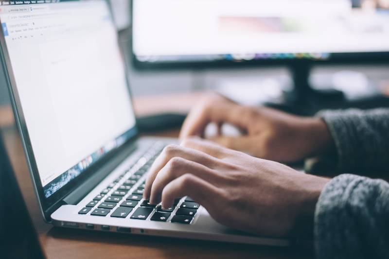 Person typing on a MacBook Pro