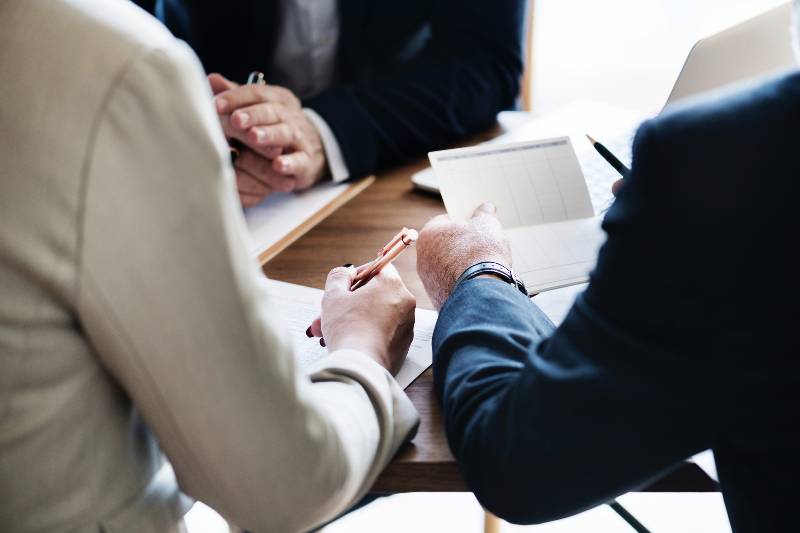 Accountants gathered at a desk, reviewing documents
