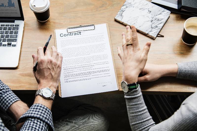 Two business people signing a contract