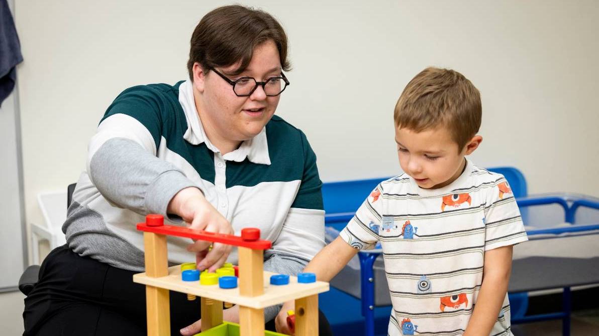 Teacher and student working.
