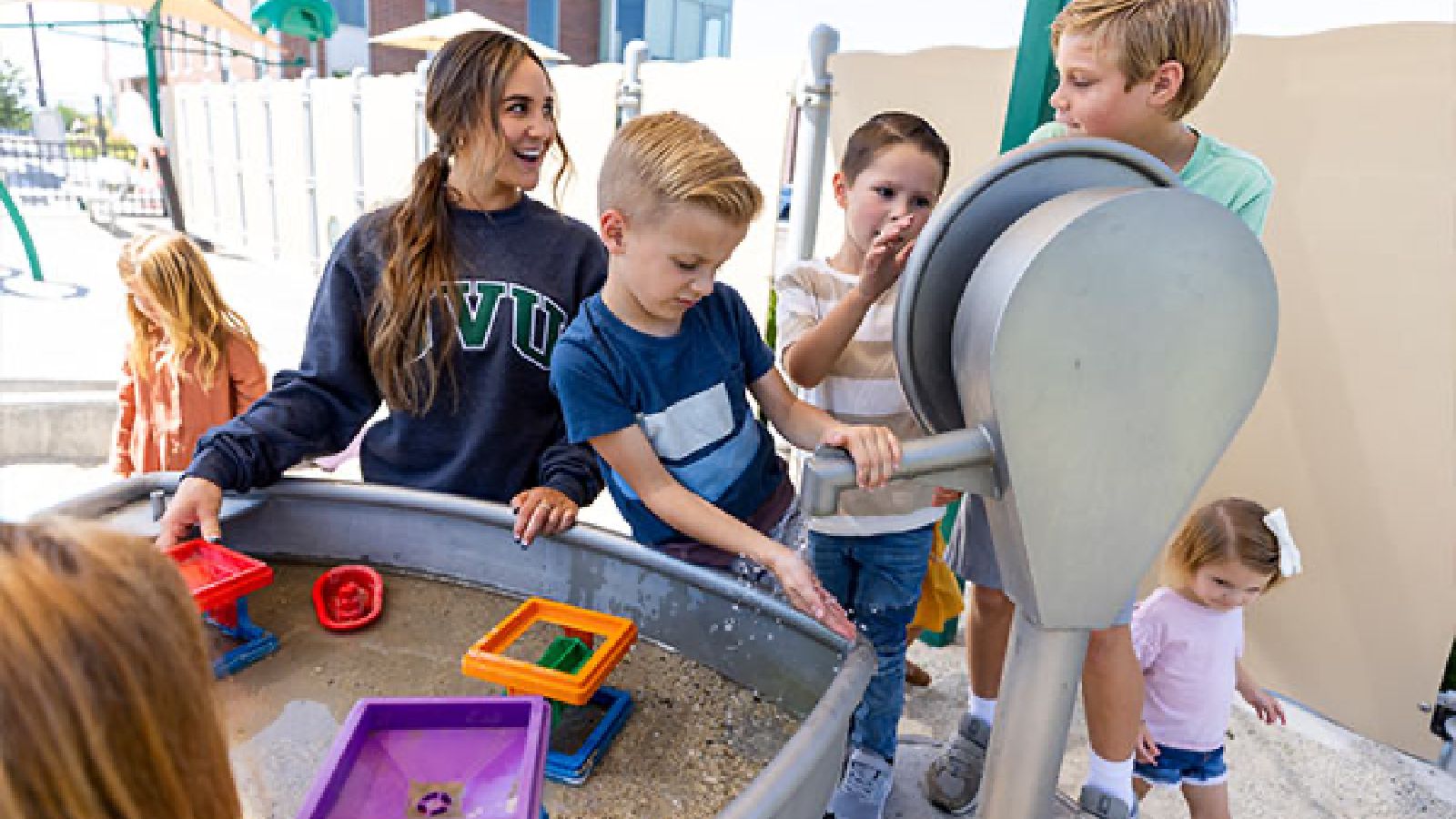 Teacher working with a group of elementary school children.