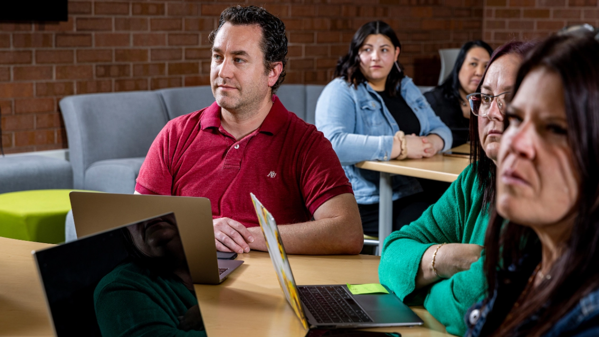 Group of adults seated at tables.