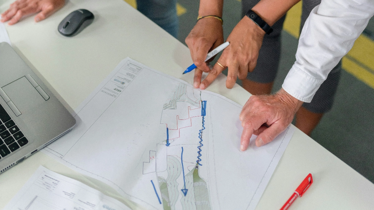 Detail of people reviewing a chart.