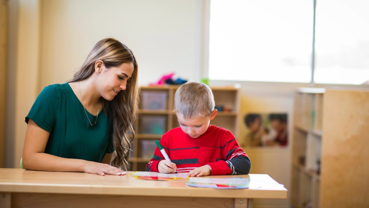 Teacher and student working.