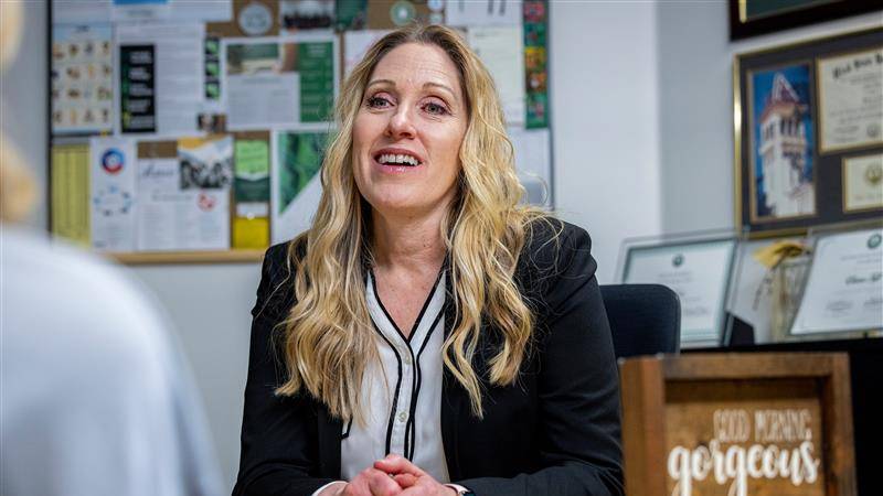 Woman sitting at a desk.