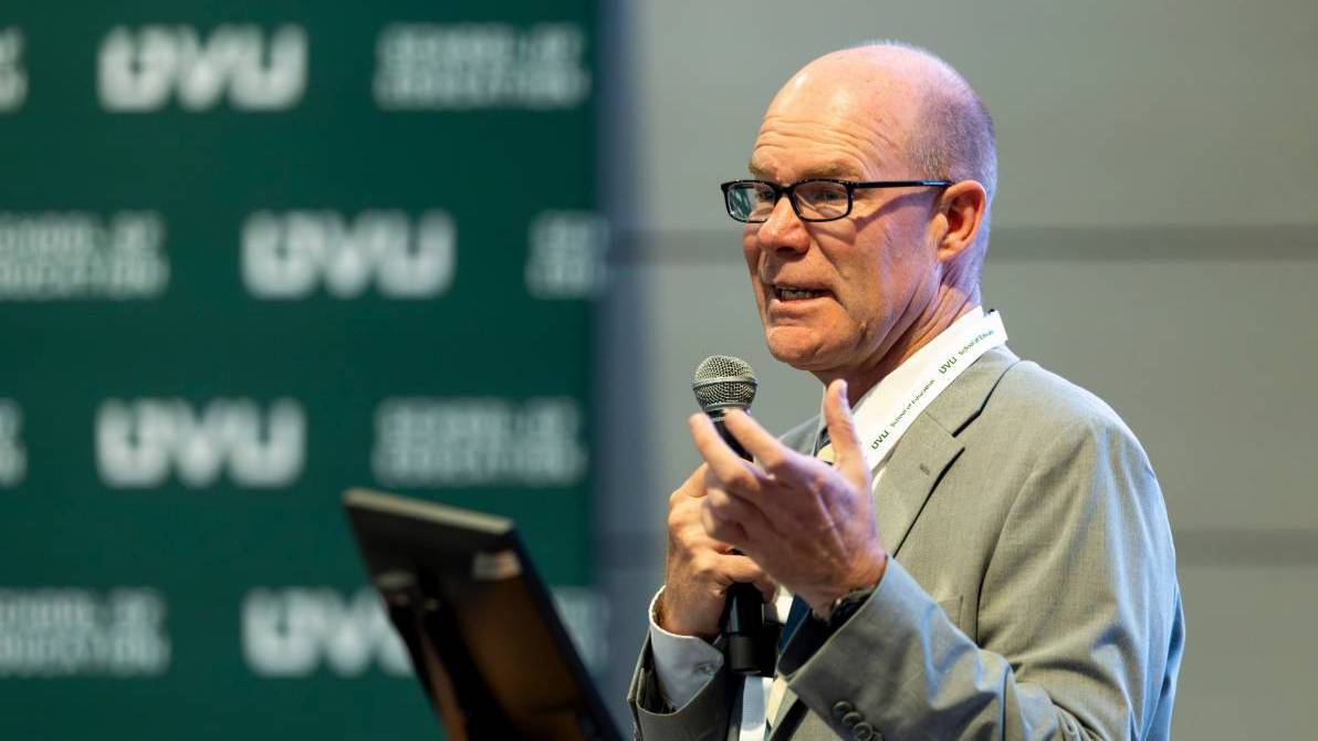 Man presenting at lecture series.