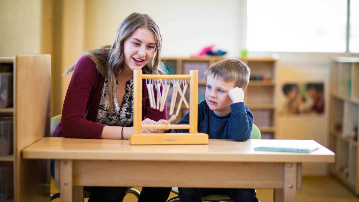Teacher and student working.