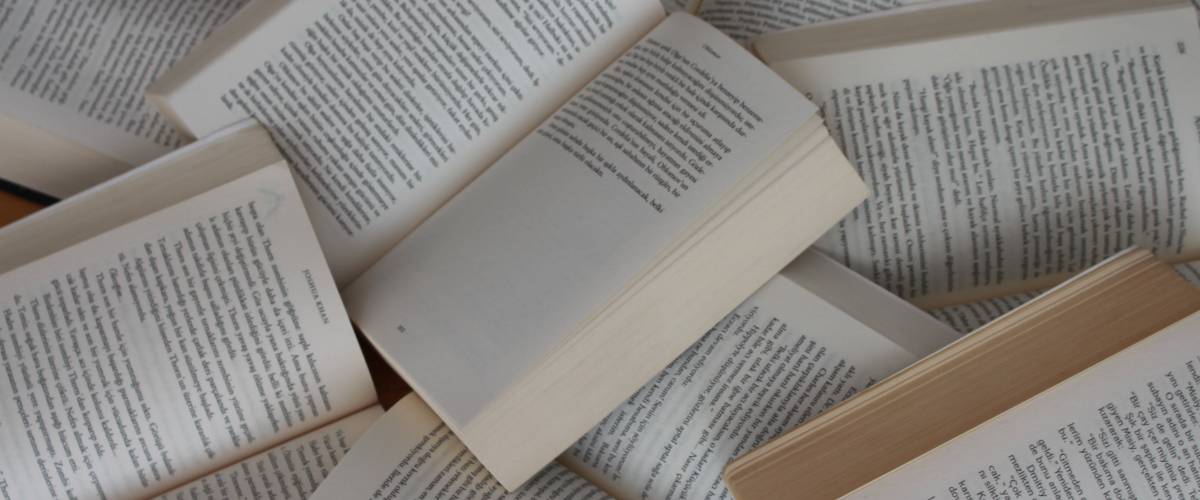 Photo of open books sprawled out across the floor