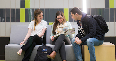 Three students sitting and talking