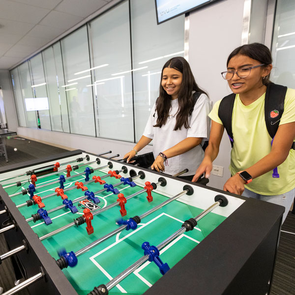 Students playing foosball at the UVU gaming center