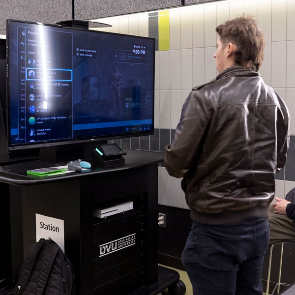 Student playing video games at the UVU gaming center