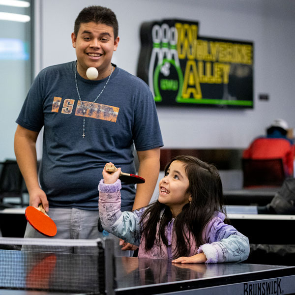 Family playing ping pong at the UVU gaming center