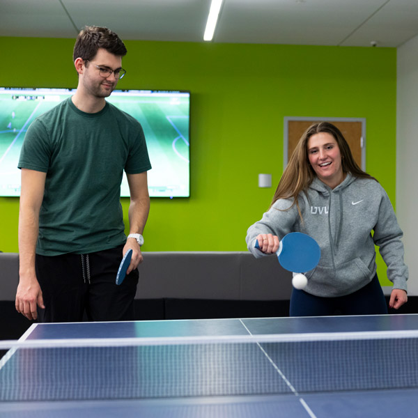 Students playing ping pong at the UVU gaming center