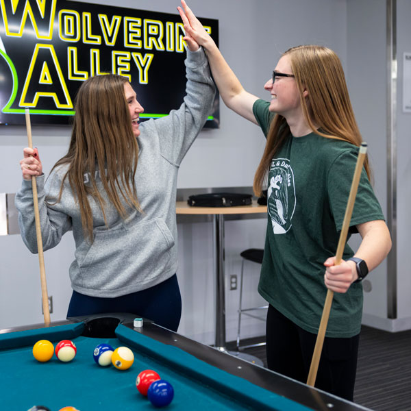 UVU student playing pool at the gaming center