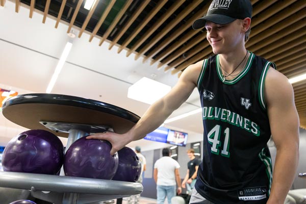 Student wearing UVU gear for Wolverine Wednesday at the bowling alley