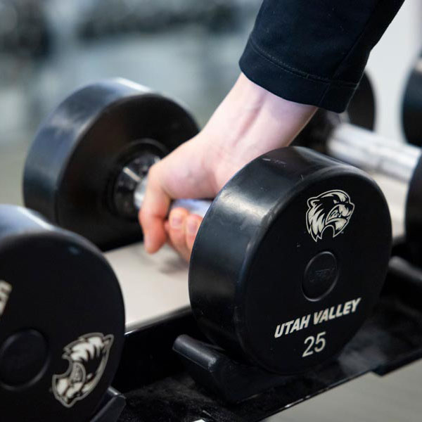 A hand grabbing a dumbell