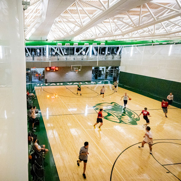 students playing basketball at the UVU fitness center courts