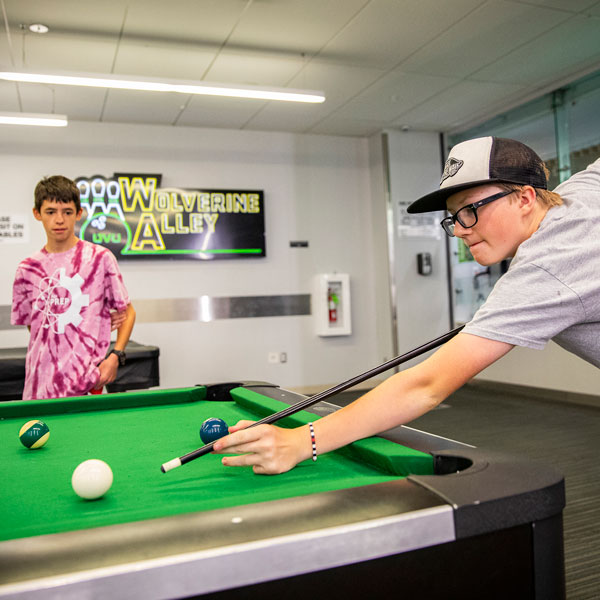 Students playing pool at the UVU gaming center