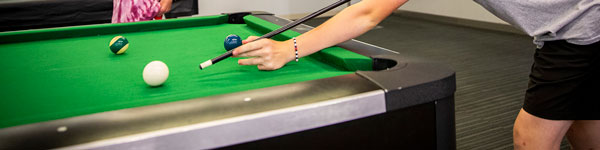 Students playing pool at the UVU gaming center