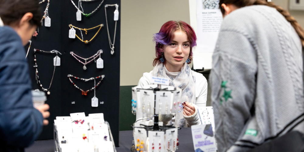UVU student entrepreneur selling items at a local valley market