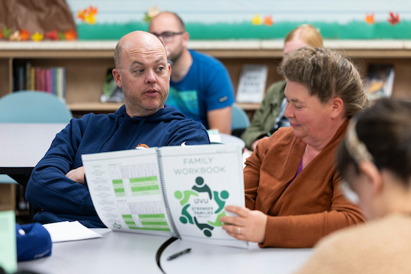 participants looking at the families workbook