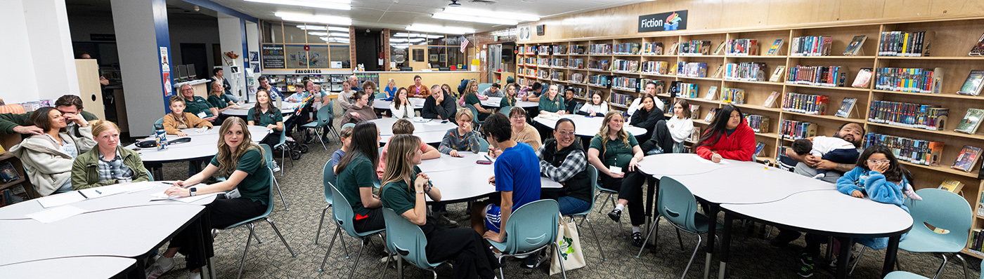 A classroom of families learning family life relationship techniques