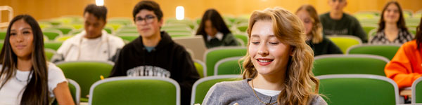 A group of students seated in a lecture hall.