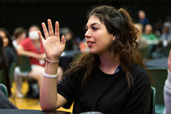BIPOC UVU student raising hand.