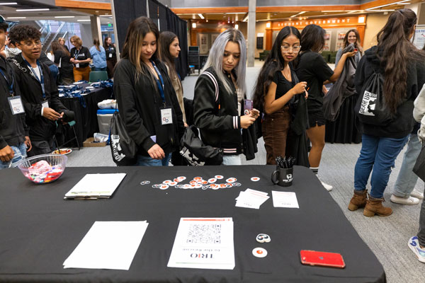 BIPOC students walking past a club table on UVU campus