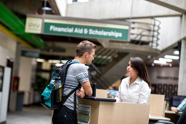 Student being helped outside the Financial Aid and Scholarships office