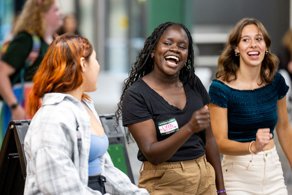 A diverse group of UVU students talking and smiling