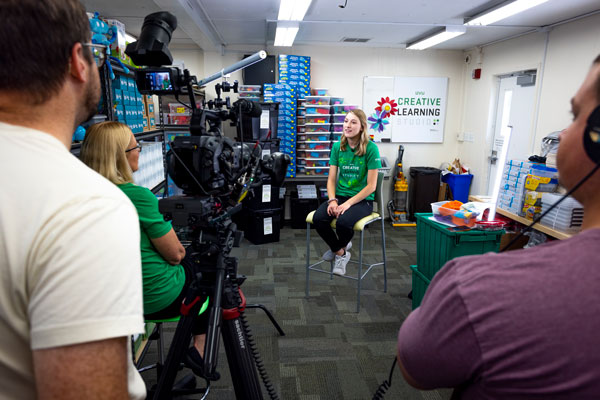 UVU student being filmed by camera crew