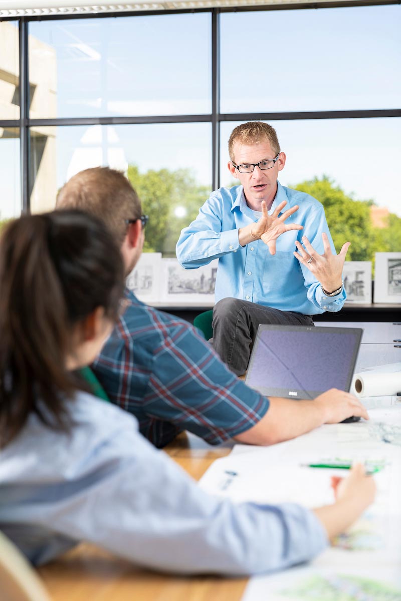 Professor showing something to students. Professor showing something to students.