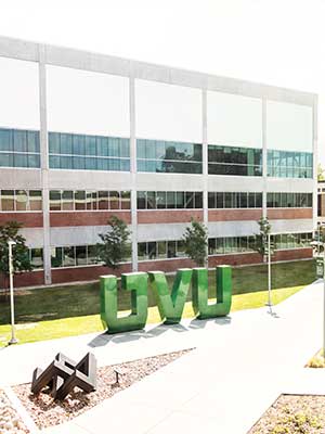 Outside the SLWC building, with a large UVU statue in the yard.