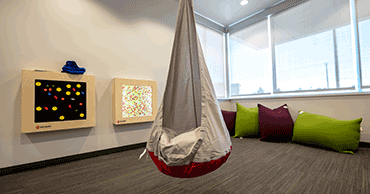 hammock and floor pillows inside center for autism