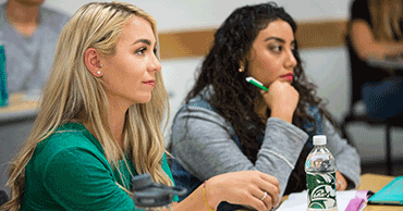 Two students sitting in a classroom