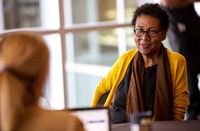 Faculty member talking to a student. 