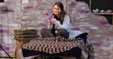 A woman sitting on a bed