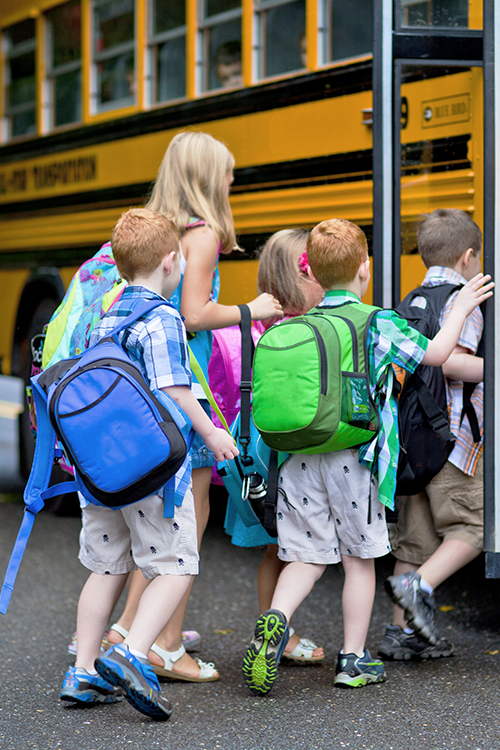 Kids getting on a bus