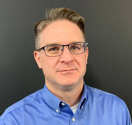Photo of David Trent. He is wearing a blue shirt 