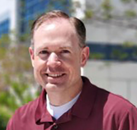 Photo of Kevin Hoyt. Caucasian male with dark hair wearing maroon polo shirt
