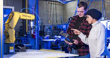 two students working in a mechatronics lab