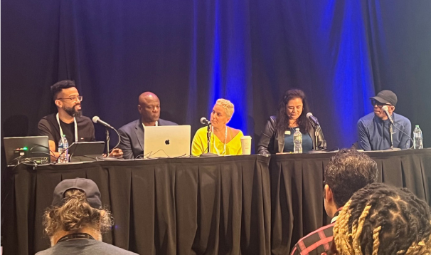 panel of speakers at a tech conference